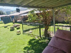 a view of a yard with a fence and a tree at Casa de campo y Chalet las Morenas in Sicuani