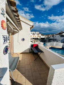 a balcony with a bench and a swimming pool at Laguna 88 in La Mata