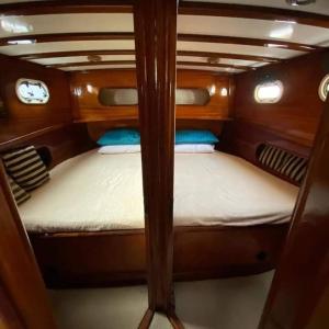 a small room with two bunk beds in a boat at YourTourKey Gulet Accommodation in Güvercin Adası