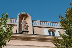 a statue of a woman on top of a building at La Madone in Apt