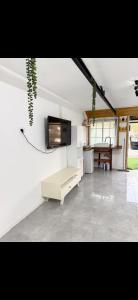 a living room with a flat screen tv on a wall at חמדת השקד in Mishmār Hāyardin