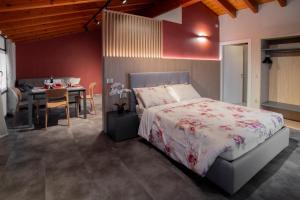 a bedroom with a bed and a dining room with a table at Terrazza Retica in Piateda