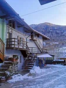 a building with stairs and snow on the ground at Casa vacanze Feltre in Feltre