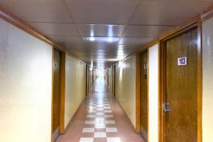 a long hallway with a long hall with a sign on it at Red Carpet Inn & Suites Lima -Listing Partner in Lima