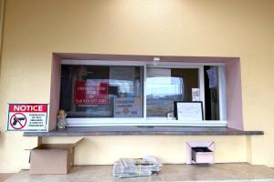 a window of a building with a sign in it at Red Carpet Inn & Suites Lima -Listing Partner in Lima