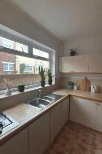 a kitchen with a sink and a window at St Joseph's Guest House in Southampton