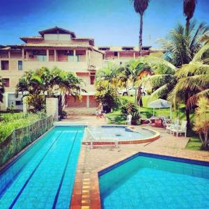 a swimming pool in front of a building at HervaDoce in Rio das Ostras