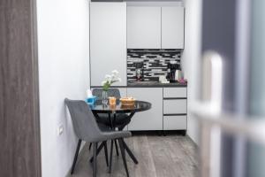 a small kitchen with a small table and chairs at Panoramic View Bran Rooms in Bran