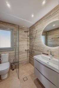 a bathroom with a toilet and a sink and a shower at Lipsi Grand Villas in Leipsoi