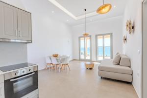 a kitchen and living room with a couch and a table at Lipsi Grand Villas in Leipsoi