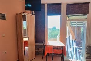 a dining room with a table and a window at Nestor Apartments in Chrysi Ammoudia