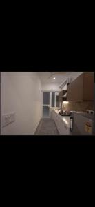 a kitchen with white counters and white cabinets at The carmine house-Private 4 BHk luxury retreat in sector 132, Noida in Noida +9 photos