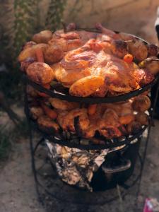 a pile of food on top of a grill at Cozy House in Wadi Musa
