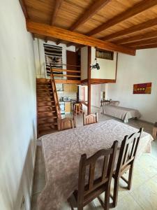 a room with a table and chairs and a living room at Pepina Mina Clavero in Mina Clavero