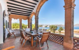 an outdoor patio with a wooden table and chairs at Es Clot in Alcudia