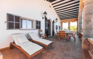 a patio with chairs and a table and a dining room at Es Clot in Alcudia +45 photos