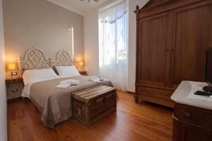 a bedroom with a bed and a large window at Casa Danilo Sanremo Centro - a 100m dalla Spiaggia in Sanremo