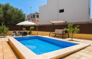 a swimming pool on a patio with an umbrella at Calamari 7 in Portocolom