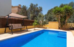 a swimming pool with a chair and an umbrella next to it at Calamari 7 in Portocolom