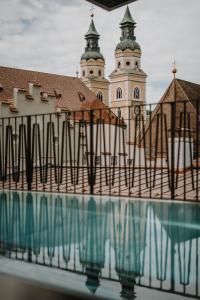 a building with a clock tower in the background at ADLER Historic Guesthouse in Bressanone