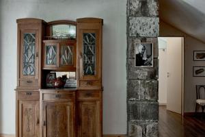 a wooden cabinet in a room with a pillar at Villa Kars in Gyumri