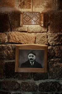 a picture of a man on a brick wall at Villa Kars in Gyumri