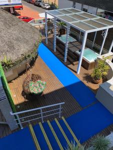 a house with a deck with a glass roof at CAPÃO Da CANOA MAR HOTEL in Capão da Canoa