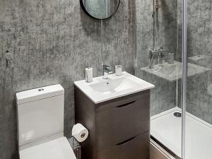 a bathroom with a sink and a toilet and a shower at 13 Doomgate Cottage - Uk45056 in Appleby +2 photos