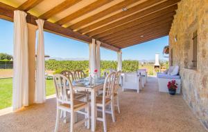 a dining room with a table and chairs on a patio at Can Ferrer in Alcudia