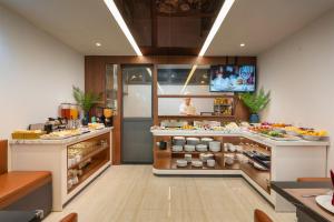 a kitchen with a counter with food on it at Sora Hotel Hanoi in Hanoi
