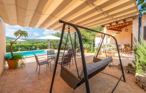 a porch with a swing and a pool at Clonenell in Canyamel