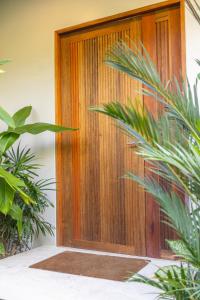 a wooden door with plants in front of it at Ocean Villa in Ko Phangan +39 photos