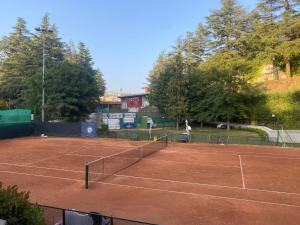 a tennis court with two people on it at Bed & Breakfast da Charlie in LʼAquila