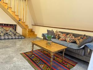 a living room with a couch and a coffee table at Boss House in Quba