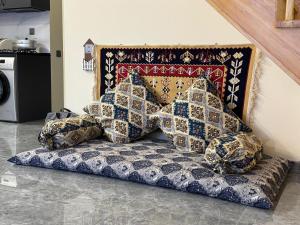 a bed with pillows on it in a room at Boss House in Quba +10 photos