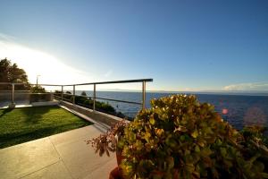 a view of the ocean from the balcony of a house at Seafront Holiday Home - Private Jacuzzi in Blato +41 photos