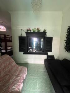 a living room with a fireplace and a couch at Gandasari Homestay Banyuwangi in Dadapan +5 photos