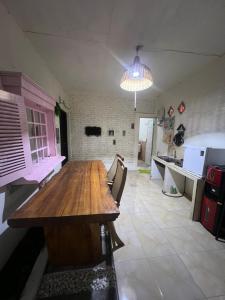 a kitchen with a large wooden table in a room at Gandasari Homestay Banyuwangi in Dadapan