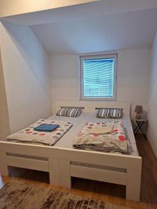 a large bed in a room with a window at FLAMANITA APARTMENTS in Skopje