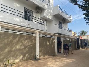 a group of people standing outside of a building at keur Baye fall fall saly in Sali Nianiaral