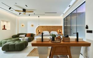 a bedroom with a bed and a living room at Diastar Luxury Suites NEW in Heraklio