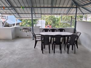 a table and chairs in a room with a table and chairs at Eleeza Homestay in Cochin
