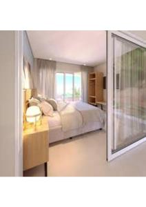 a bedroom with a large bed and a window at RESORT PITANGUI BEACHs in Extremóz