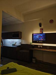 a room with a flat screen tv on the wall at The Urban Perch in Greater Noida