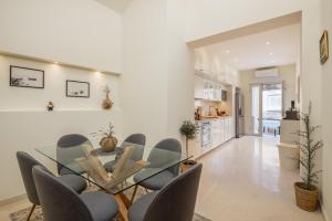 a dining room with a glass table and chairs at Villa Nada - Unique & Artistic in Korčula
