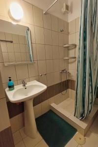 a bathroom with a sink and a shower at Nestor Apartments in Chrysi Ammoudia +122 photos