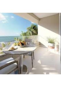 a table with a plate of fruit on it on the beach at RESORT PITANGUI BEACHs in Extremóz