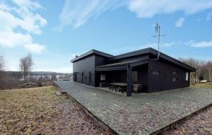 a black building with a train track in front of it at Stunning Home In Örkelljunga With Sauna in Orkelljunga +14 photos