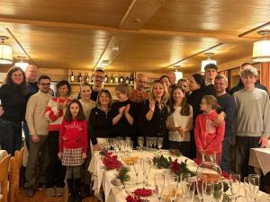 a group of people posing for a picture at a table at Hotel Panorama in Cavalese +39 photos