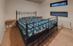 a bedroom with a black bed in a room at Stunning Home In Örkelljunga With Sauna in Orkelljunga